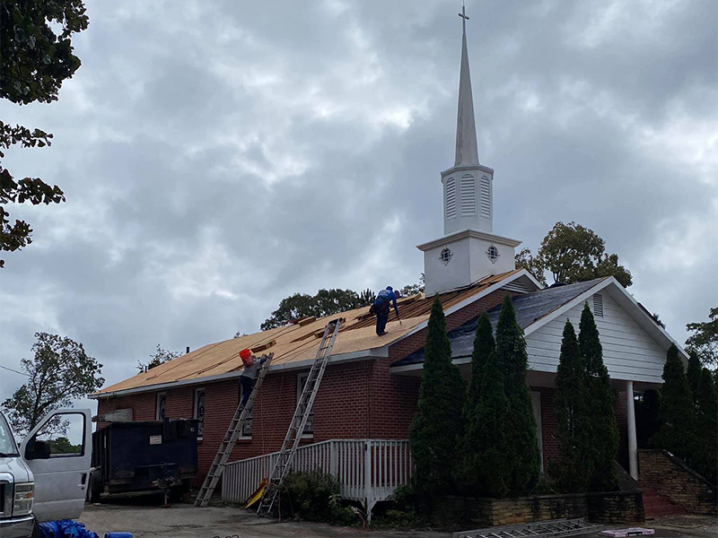 group of contractors installing new roof at church flowery branch ga