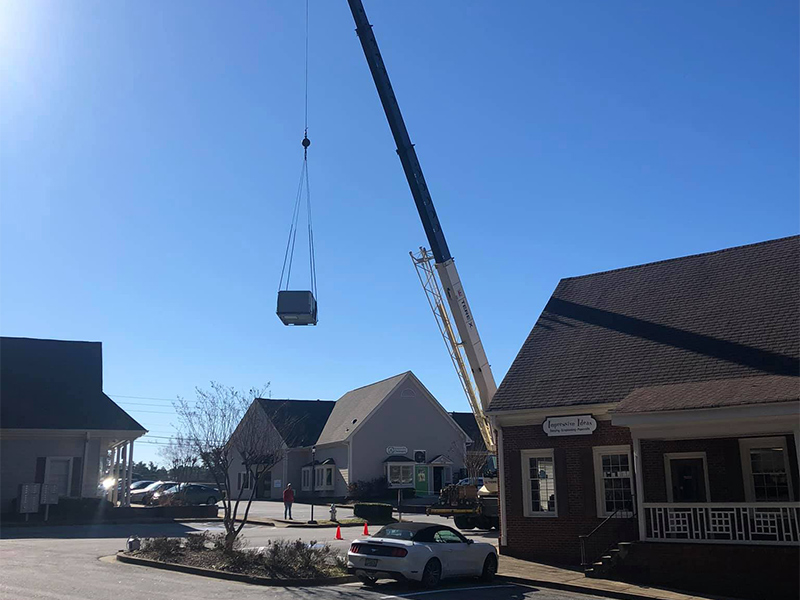 roofing company with heavy machinery carrying equipment for roof installation flowery branch ga